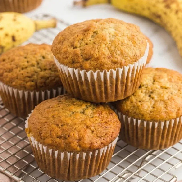 Freshly baked golden brown banana muffins in a muffin tin.